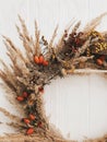 Fall wreath made of dried herbs, flowers, berries, wildflowers