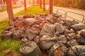 Fallen autumn leaves gathered in biodegradable plastic bags. Black plastic garbage bags in the park, autumn cleaning