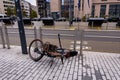 Fallen bicycle locked to bike rack on the street