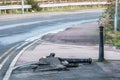Fallen broken metalic road post on footpath in england