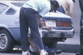 Fallen homeless man in city street getting help, Los Angeles, California