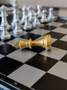 Fallen golden King chess piece