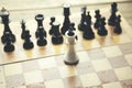 Fallen king pieces surrounded by the other color chess pieces Royalty Free Stock Photo