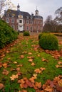 Fallen leaves in front of a monumental castle in Ruurlo