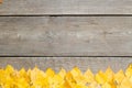 Fallen leaves on a wooden table. Yellow and red leaves on old table boards. Autumn leaves fallen on the table. Royalty Free Stock Photo