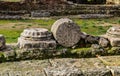 Fallen pillars in the ruins of Olympia Greece with ancient paving stones in the foreground and a rubble wall behind Royalty Free Stock Photo