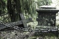 Fallen ÃÂross and chain at old beautiful semetery in Finland