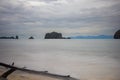 Fallen tree on the beach of Pantai Tanjung Rhu on the malaysia island Langkawi. Clouds over the bay. Silky water. Silk effect in Royalty Free Stock Photo