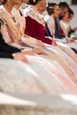 Fallera dresses, bright colors and reflections in these typical costumes of the fallas of Valencia. Falleras seated in a public