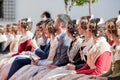 Falleras sitting on a public event in Valencia during the celebration of the Fallas