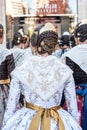 Falleras standing seen from behind. Typical hairstyle of the Valencia holidays celebrated in March