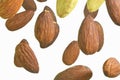 Falling almonds isolated on a white background, selective focus. Almond nuts levitate on a white background. Freeze