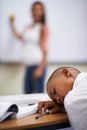 Falling asleep in class. A young boy sleeping in class. Royalty Free Stock Photo