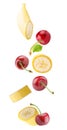 Falling banana and cherry fruits isolated on white background