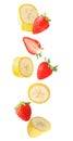 Falling banana and strawberry fruits isolated on white background