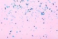 Falling blue confetti on pink background Royalty Free Stock Photo