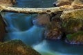 Falling blurred water among the stones Royalty Free Stock Photo