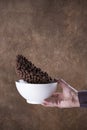 falling chocolate balls into a white bowl on brown background. levitation. Royalty Free Stock Photo