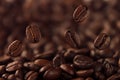 Falling coffee bean on background of heap of roasted beans.