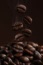 Falling coffee beans in hot steam close-up Royalty Free Stock Photo
