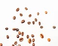 Falling coffee beans isolated on white background, clipping path, full depth of field. Cereal product. Hot drink. Close up. Royalty Free Stock Photo