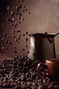 Falling coffee beans and old copper coffee maker Royalty Free Stock Photo