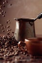 Falling coffee beans and old copper coffee maker Royalty Free Stock Photo