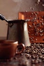 Falling coffee beans and old copper coffee maker Royalty Free Stock Photo