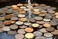 Falling coins in a water fountain. Selective focus on coins