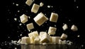 Falling cubes of white cheese isolated on black background Royalty Free Stock Photo