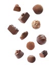 Falling different chocolate candies on background