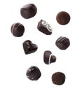 Falling different chocolate candies on background