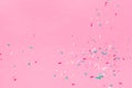Falling down trendy futuristic neon sprinkles on pink background