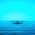 a falling drop and diverging circles on the water on a blue background Royalty Free Stock Photo