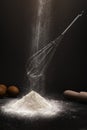 Falling flour on whisk baking ingredients