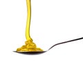 Falling and flowing honey on a spoon isolated on white with clipping path Royalty Free Stock Photo