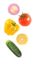 Falling flying vegetables bell pepper, onion, lemon, cucumber, tomato isolated on white background with clipping path Royalty Free Stock Photo