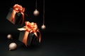 Falling gift boxes with orange ribbon, balls with copy space. Xmas present,
