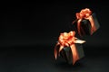 Falling gift boxes with orange ribbon with copy space. Xmas present,
