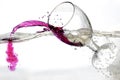 Falling a glass of red wine into water Royalty Free Stock Photo