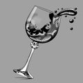 Falling glass with splashed wine on gray