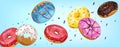 Falling glazed sweet buns on blue background. Realistic Colorful donuts with pink, chocolate, blue, yellow and white