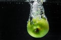 Falling green apple water, splashes for design, freezing in motion Royalty Free Stock Photo