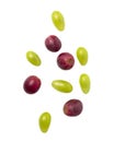 Falling green and red grapes isolated on white background with clipping path. Royalty Free Stock Photo