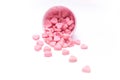 Falling heart candy in Pink polka dot paper cups isolated