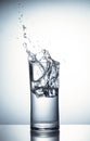 Falling ice cubes in a glass of water with splash Royalty Free Stock Photo