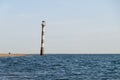 Falling Kiipsaare lighthouse in water of Baltic sea