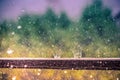 Falling rain and splashing drops outside. Storm on a sunny day, beautiful light and wonderful colors. Royalty Free Stock Photo