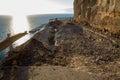 Falling rocks and big collapse hole on closed mountain road under the sea Royalty Free Stock Photo