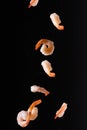 Falling shrimp on a black background, close-up. Seafood, wholesome food, culinary background